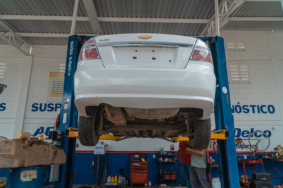 Car elevated on a hydraulic lift for tire rotation service