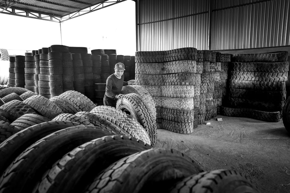 Stacks of seasonal tires organized in a large warehouse