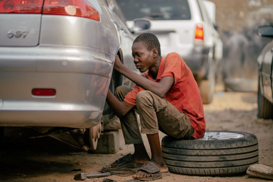 Mechanic changing a car tire in a professional garage setting
